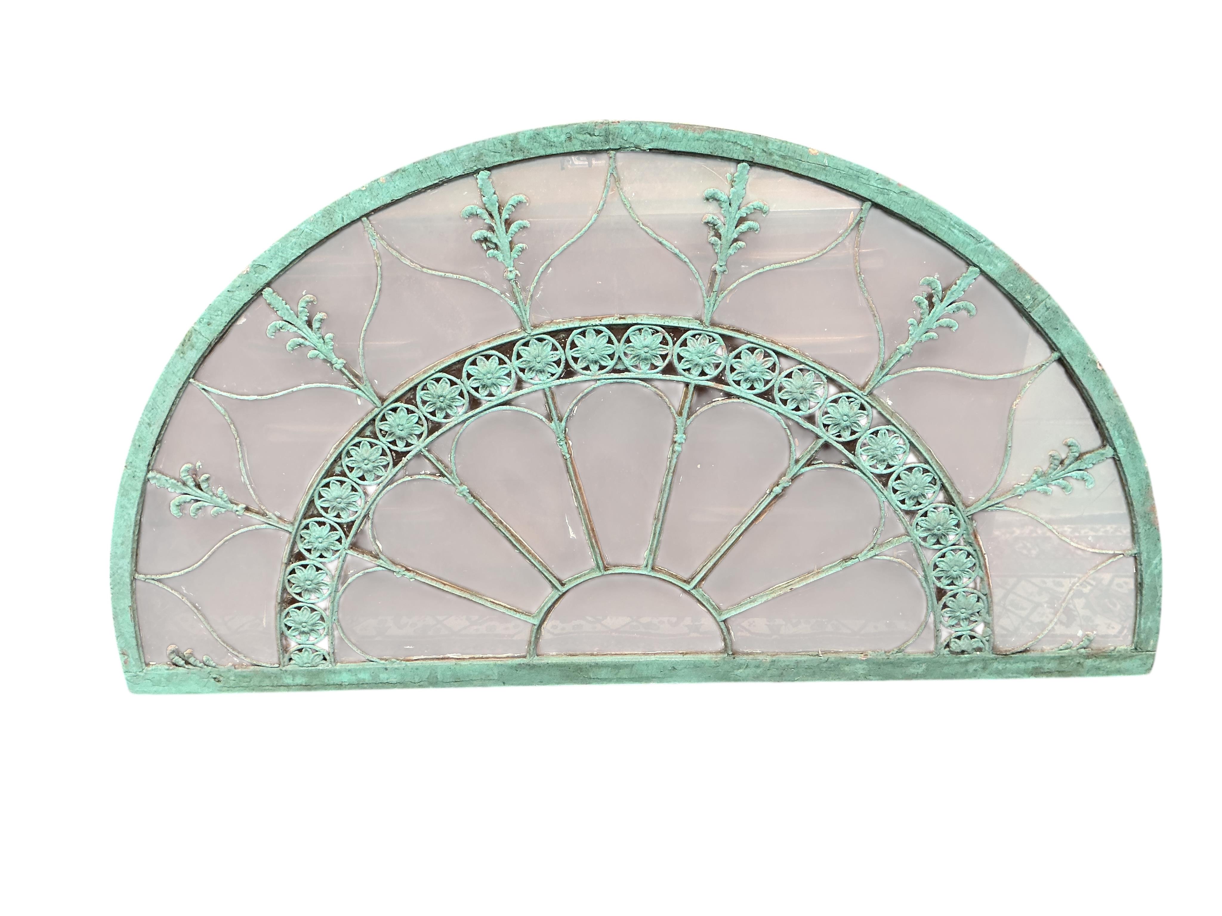 A 19th century wood and wrought iron fan light, later painted, width 170cm, height 91cm